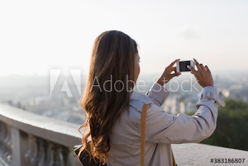 Businesswoman using camera phone, Montmartre, Paris, France