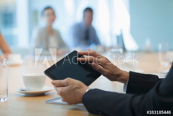 Businesswoman using digital tablet in conference room meeting