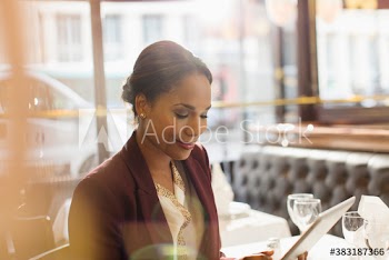 Businesswoman using digital tablet in restaurant