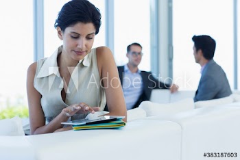 Businesswoman using digital tablet on sofa