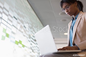 Businesswoman using laptop in office