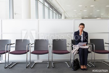 Businesswoman with resume preparing for job interview in office lobby
