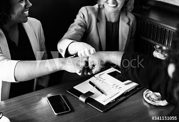 Businesswomen in a fist bump