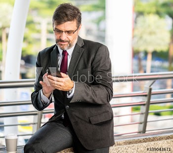 Busy businessman checking his phone