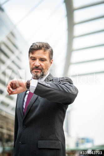 Busy businessman checking his watch