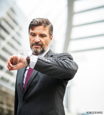 Busy businessman checking his watch