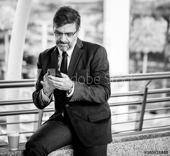 Busy businessman using his phone