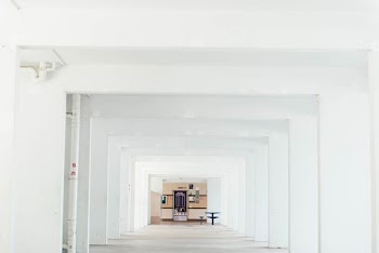 cabinet and table inside white concrete building