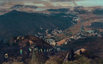 cable cars on mountain during daytime