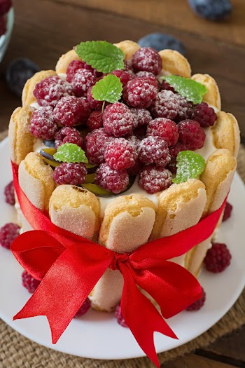 Cake "charlotte " with raspberries and plums. Free Photo