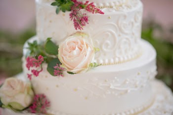 Cake With White Icing and Pink Rose