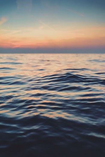 calm body of water at golden hour