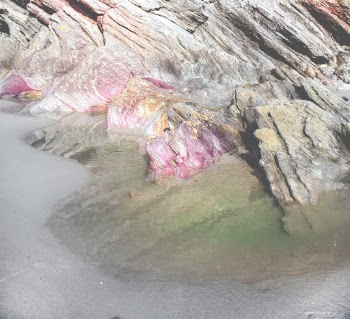 Calm Body of Water in Front of Rock Formation