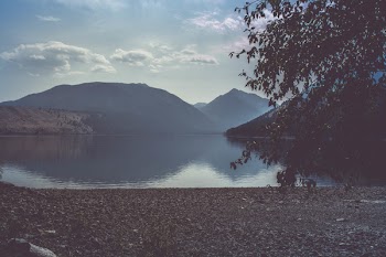 Calm Body of Water Near Mountain