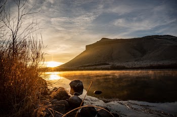 Calm Body Of Water Near Mountain During Golden Hour