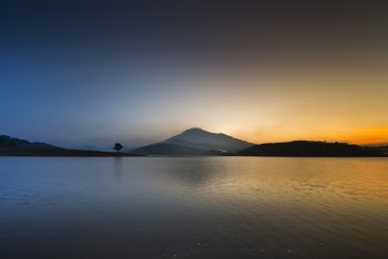 Calm Body of Water Near Mountain View