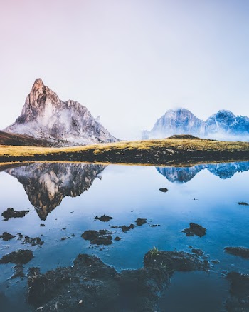 Calm Body of Water Near Mountains