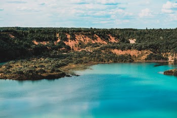 Calm Body of Water Under Blue Sky