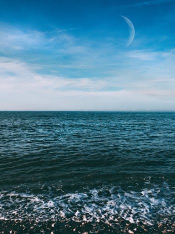 Calm Body of Water Under Blue Sky