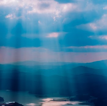 Calm Body of Water Under Sun Rays