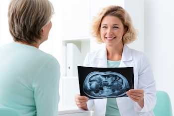 Calm Doctor Discussing Abdominal Scan Results with Patient