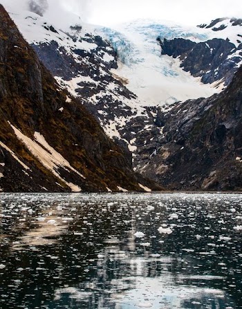 calm lake near glacier mountain at daytime