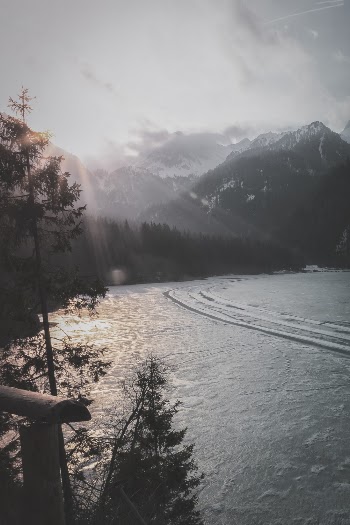 Calm of Body of Water in Front of Mountain