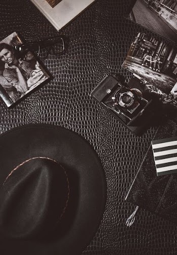 camera beside black hat