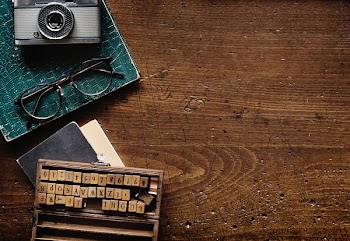 camera beside eyeglasses on table
