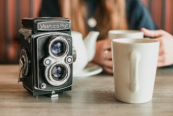 Camera Beside White Mug
