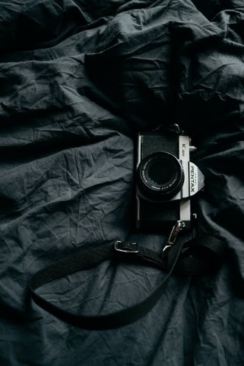 Camera Lying on Bed  · Free Stock Photo