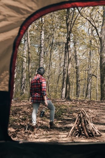 Camper Standing Outside Of Tent