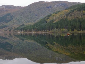 Canoe In Water By Cliffs