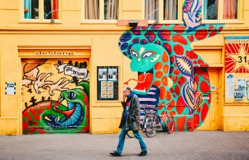 Captured this shot in Amsterdam, Netherlands. The art work and yellow paint is really lively.