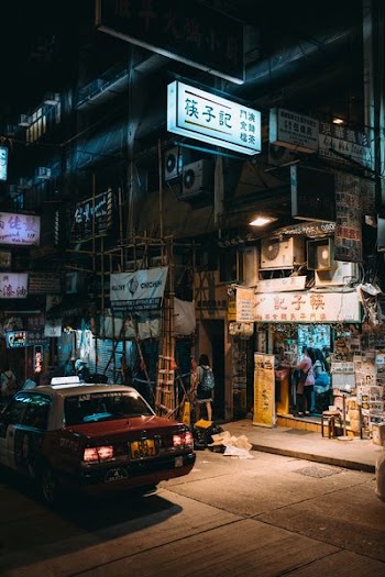 car parked beside storefront during night time