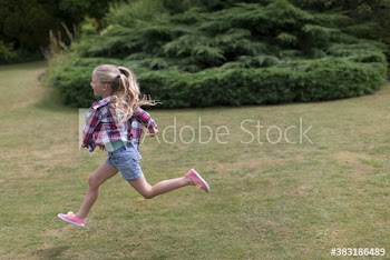 Carefree girl running in grass