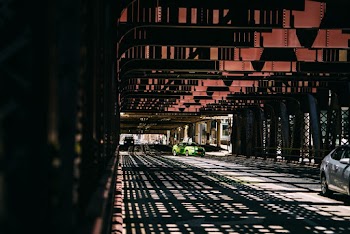 Cars Driving Under Steel Construction