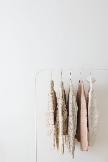 Casual knitted sweaters hanging on a rack | Free Photo - rawpixel