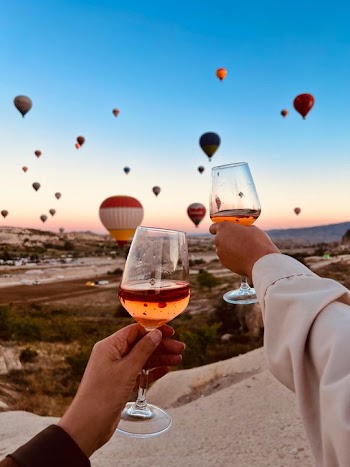 Celebratory Toast with Hot Air Balloons at Sunset