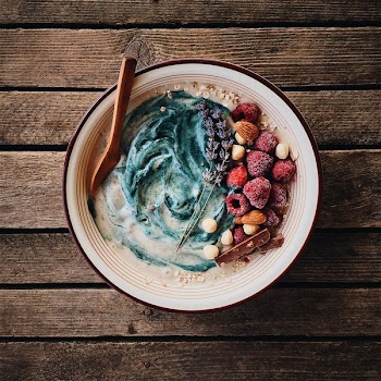 Cereals bowl with frozen raspberries and nuts 