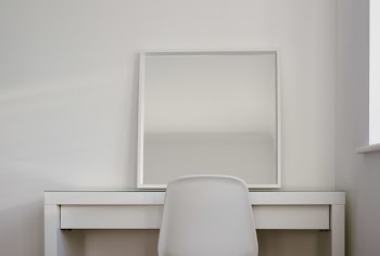 Chair in Front of Desk With Mirror on Top