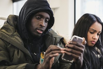 Checking Phone On Transit