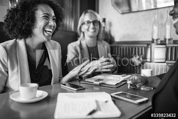 Cheerful businesswomen relaxing at a cafe