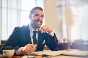 Cheerful entrepreneur at workplace Free Photo