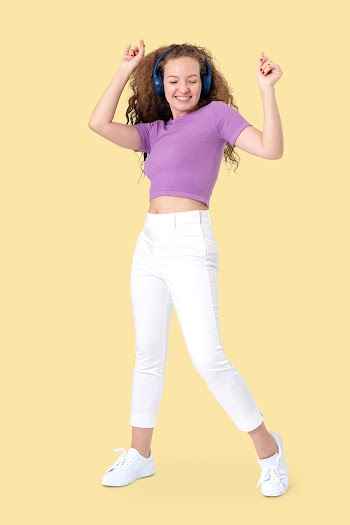 Cheerful woman dancing while listening to… | Free stock photo | High Resolution image