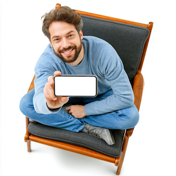 Cheerful Young Man Holding Smartphone in Cozy Setting