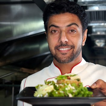 Chef Holding A Salad On Plate