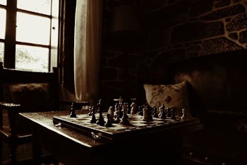 chessboard on table beside window