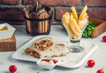 Chicken doner in lavash with french fries in the plate Free Photo