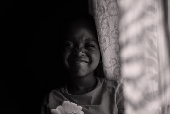 Child Beside Curtain